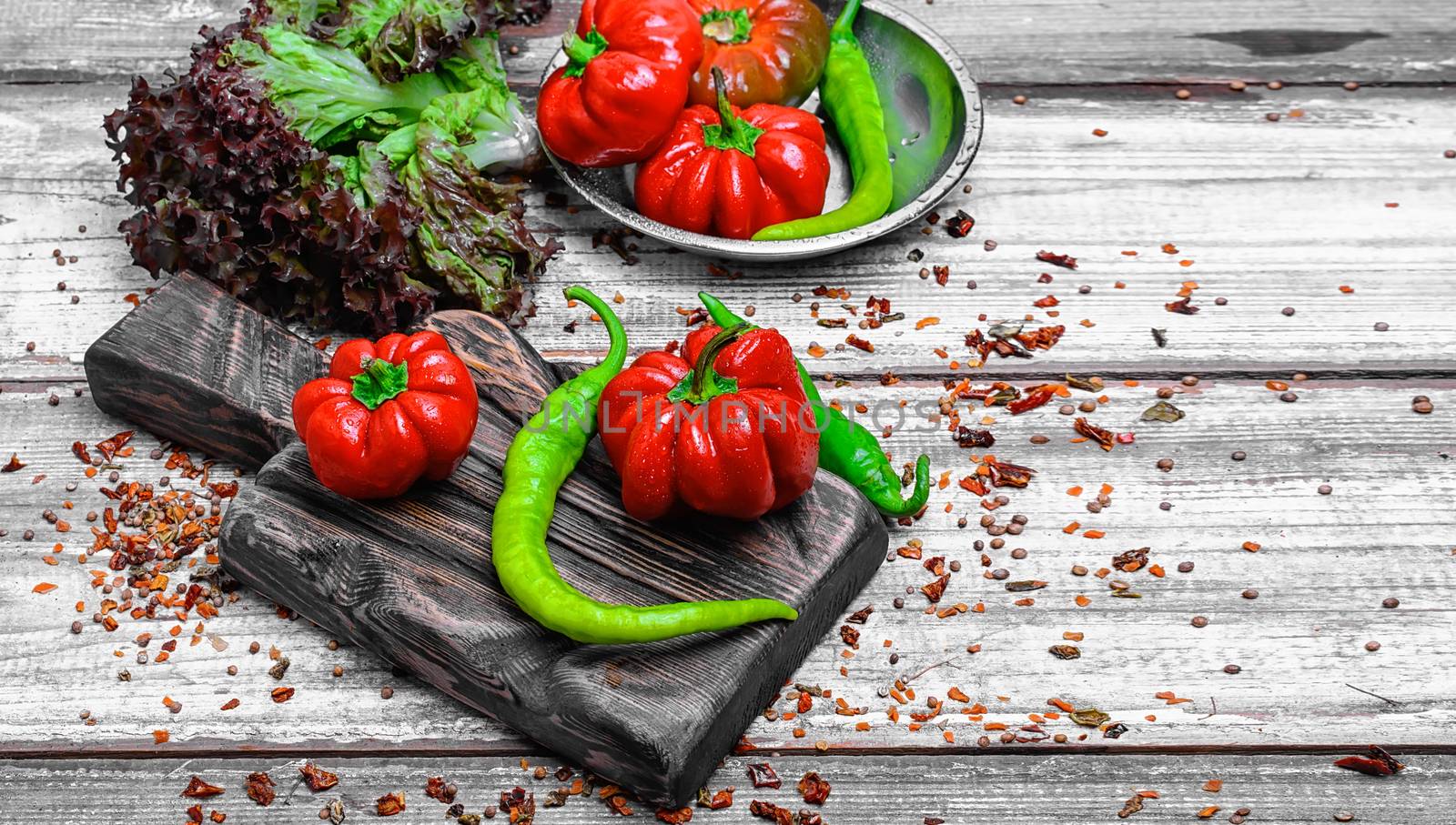 red pepper and paprika on iron plate with bright light background with spices