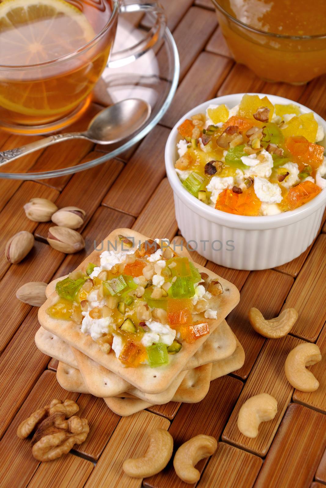 portion of cottage cheese with jam and marmalade, nuts on a cracker