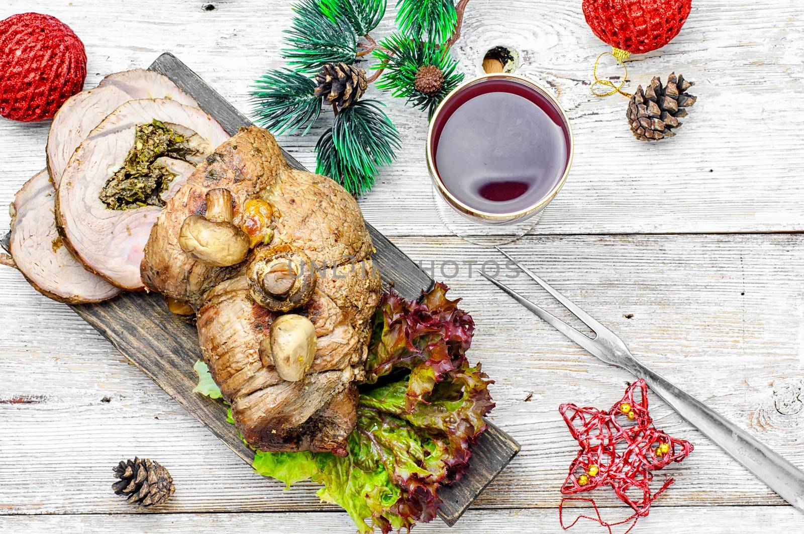 Dish of roulade of veal stuffed with mushrooms and spices and Christmas decorations