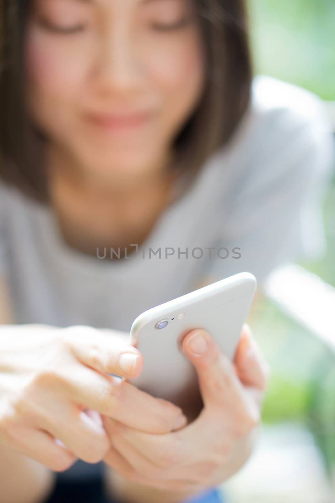 beautiful woman texting with her phone by ekachailo