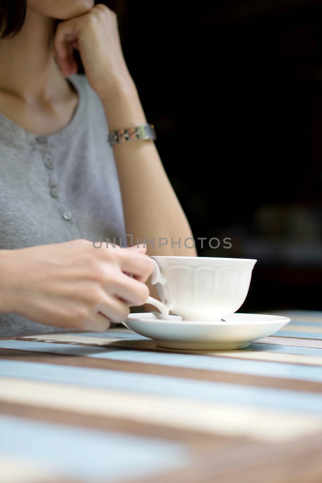 Girl's hands holding a cup of coffee by ekachailo