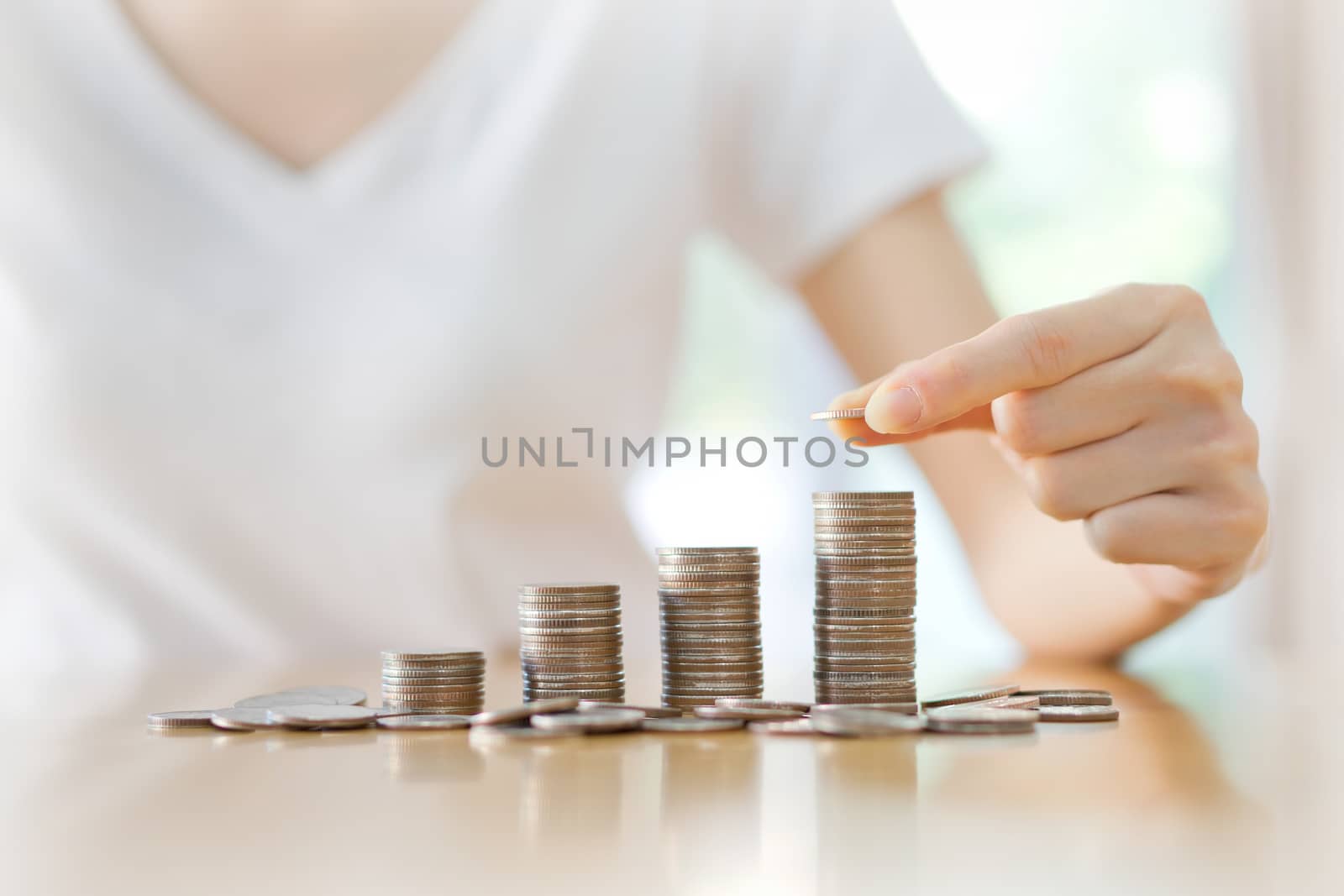 women put coin stack money for money growth concept