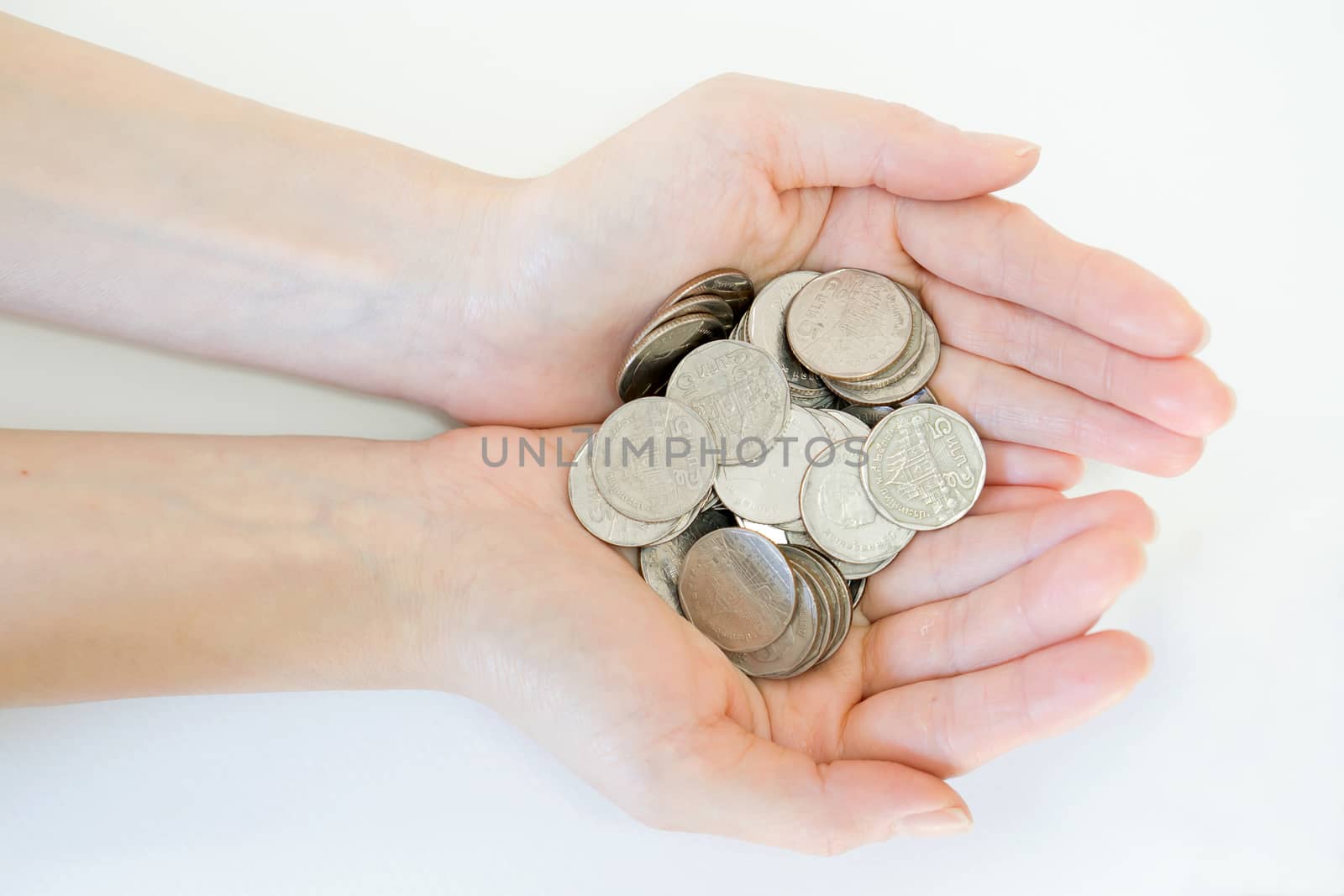 money and finances concept - close up of womans cupped hands showing coins