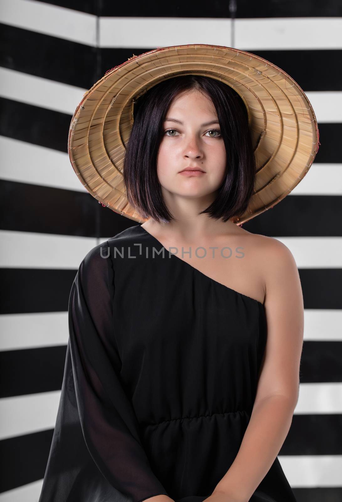 portrait of young woman in a straw hat