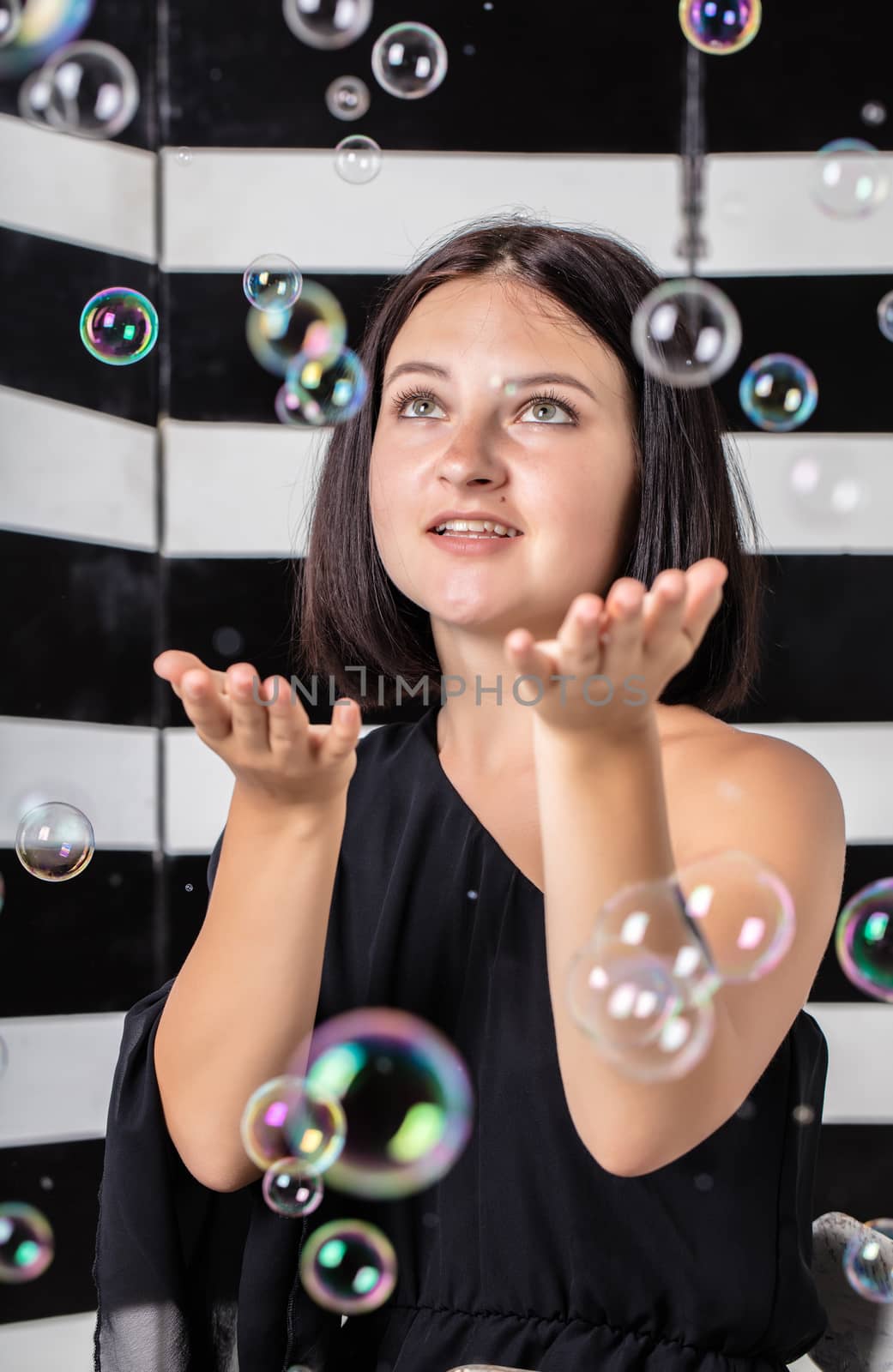 portrait of young woman with soap bubbles