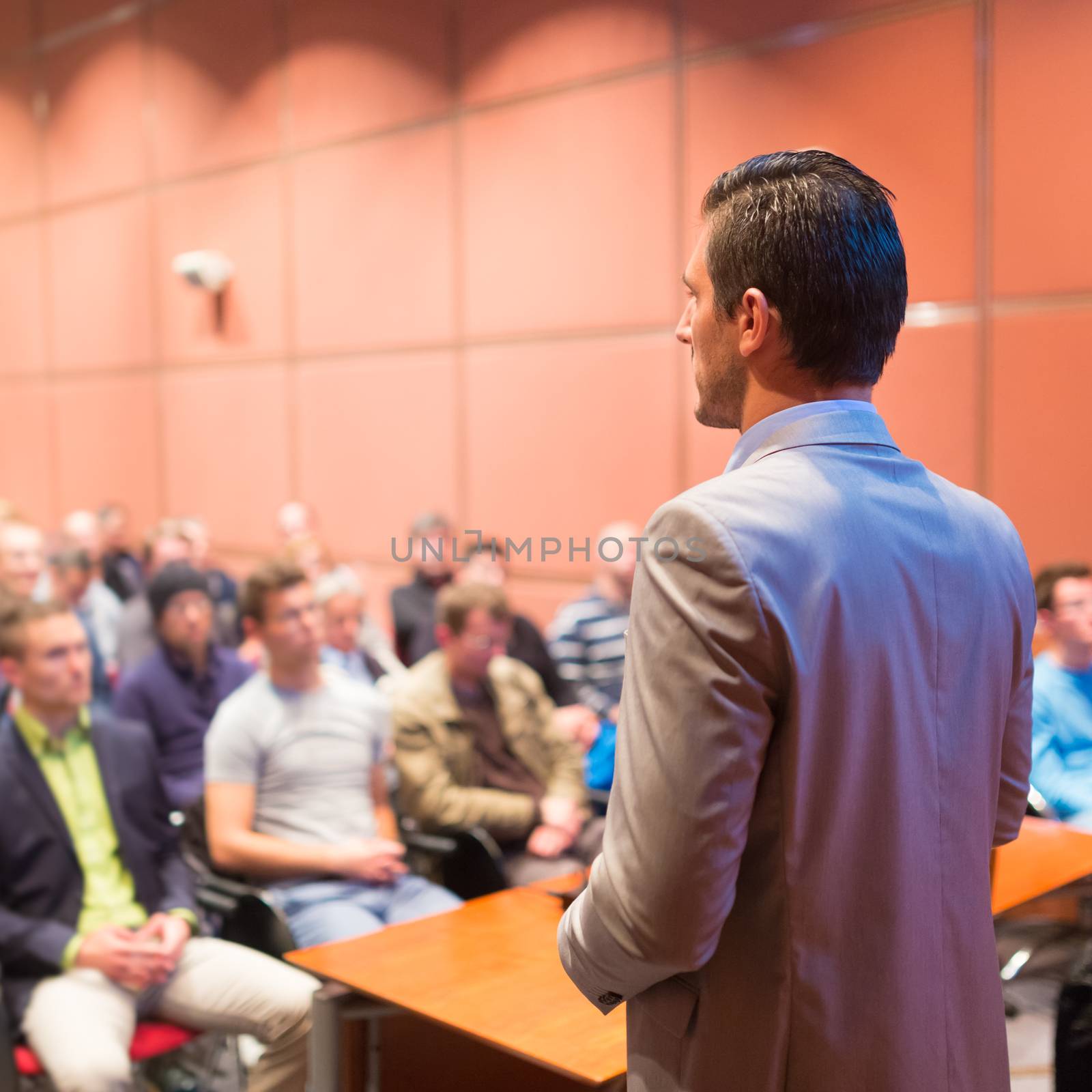 Speaker at Business Conference with Public Presentations. Audience at the conference hall. Business and Entrepreneurship concept. Background blur. Shallow depth of field.