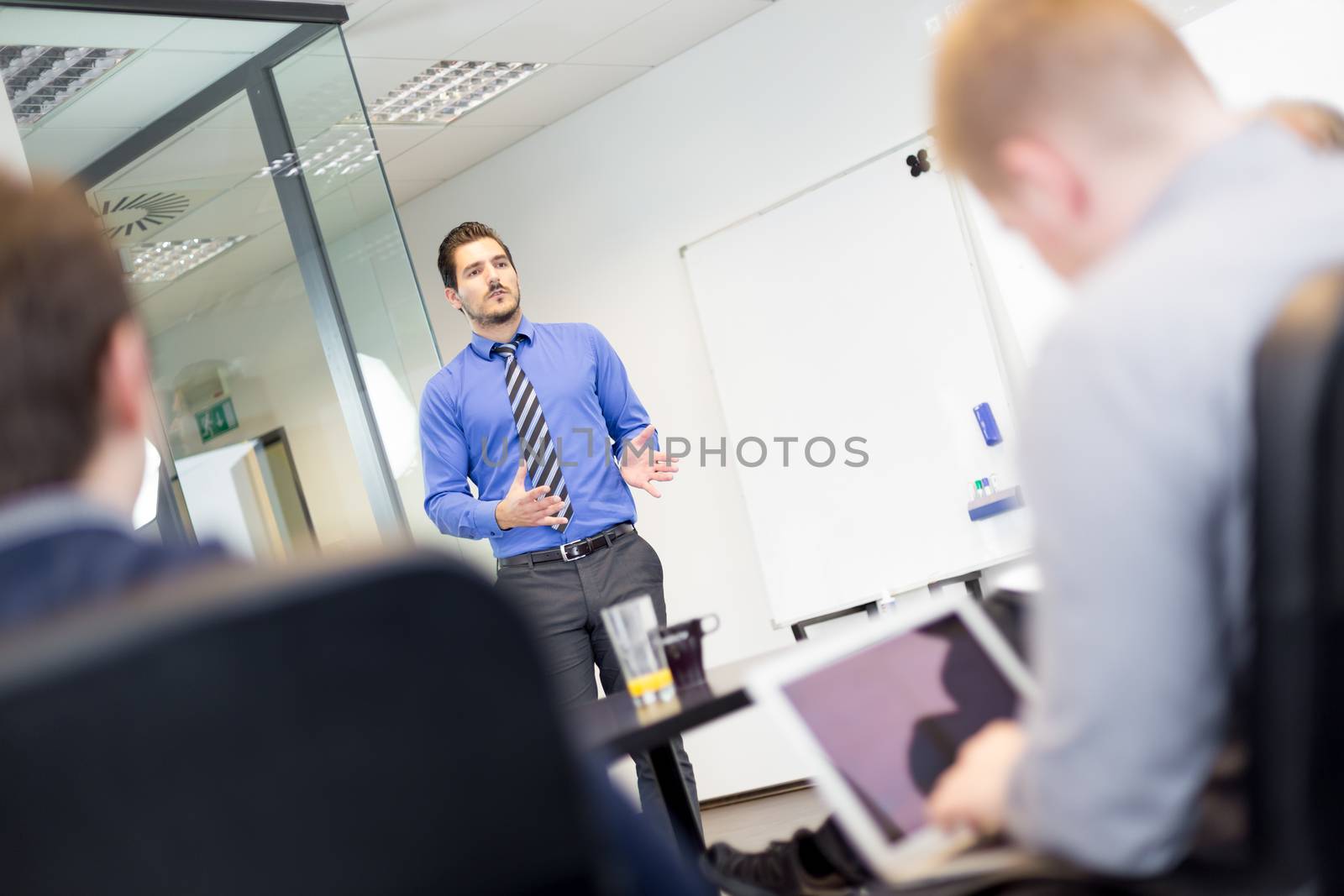 Workplace in modern office with business people brainstorming. Businessman working on laptop during the meeting.