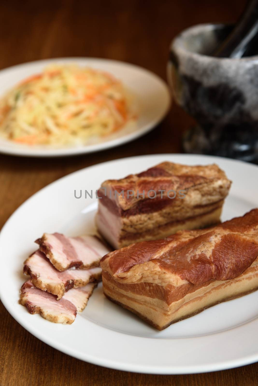 smoked pork ribs on white plate on wooden background