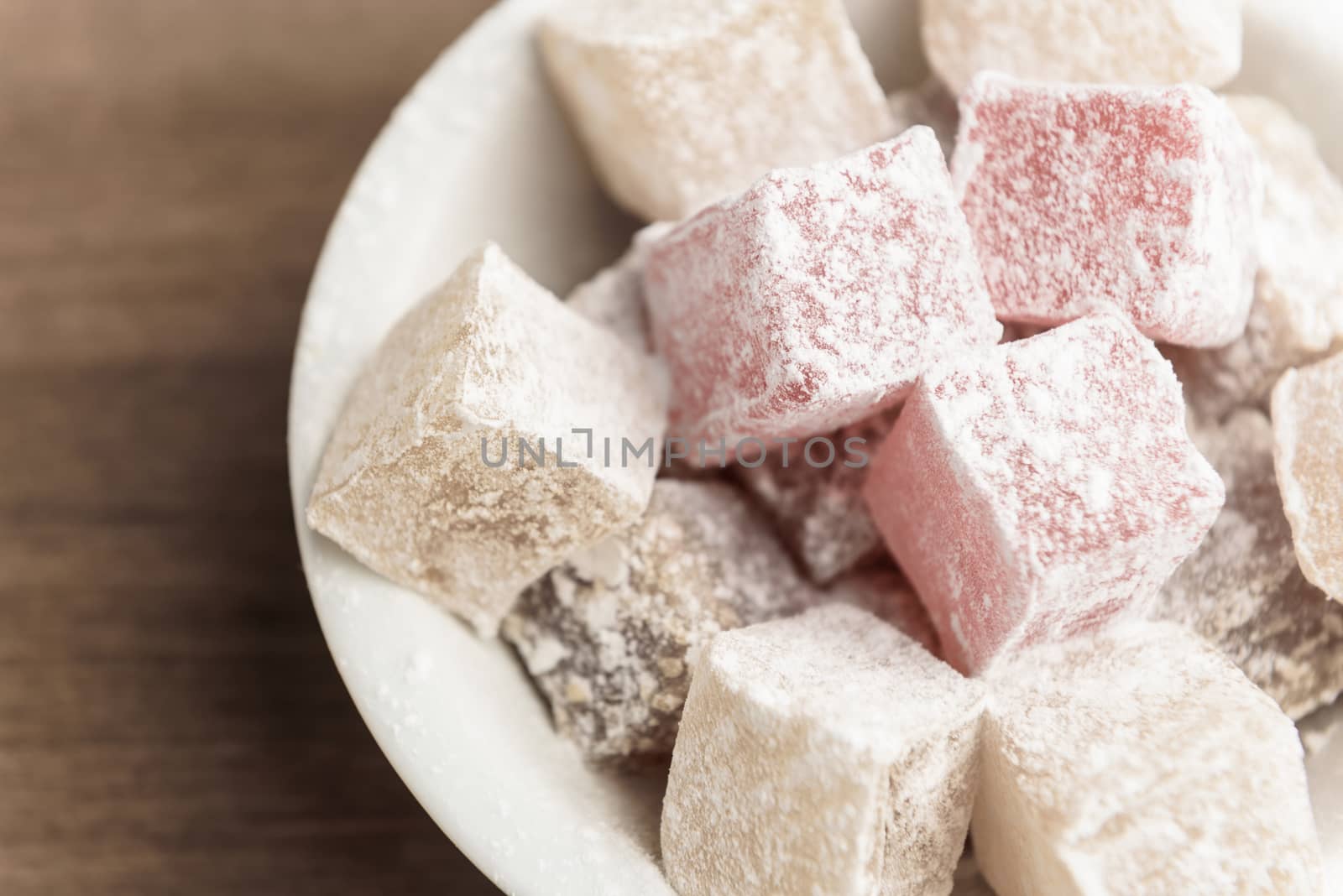 delight yellow and red on a plate sprinkled with powdered sugar