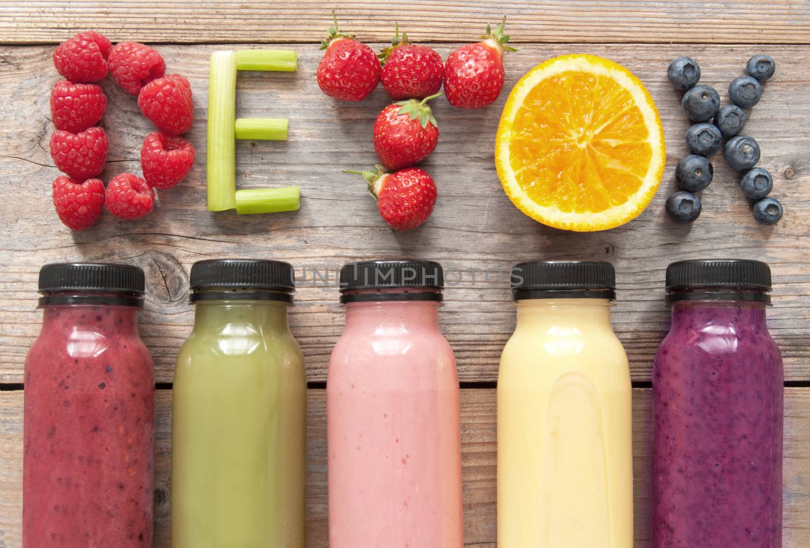 Assorted flavoured smoothie juices in bottles with detox spelt using fruits and vegetables