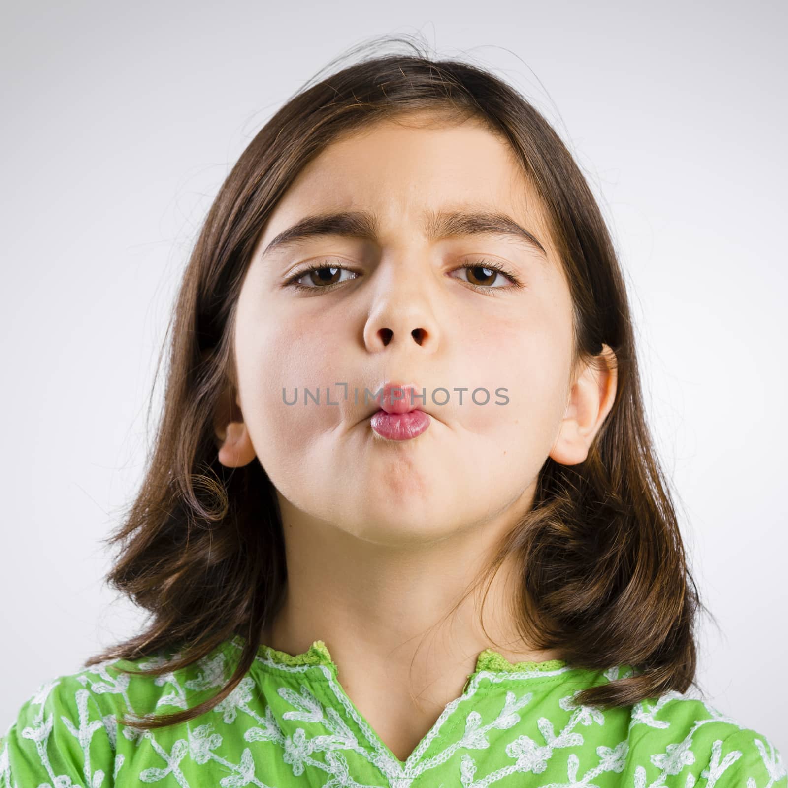 Portrait of a little girl making a fish mouth expression
