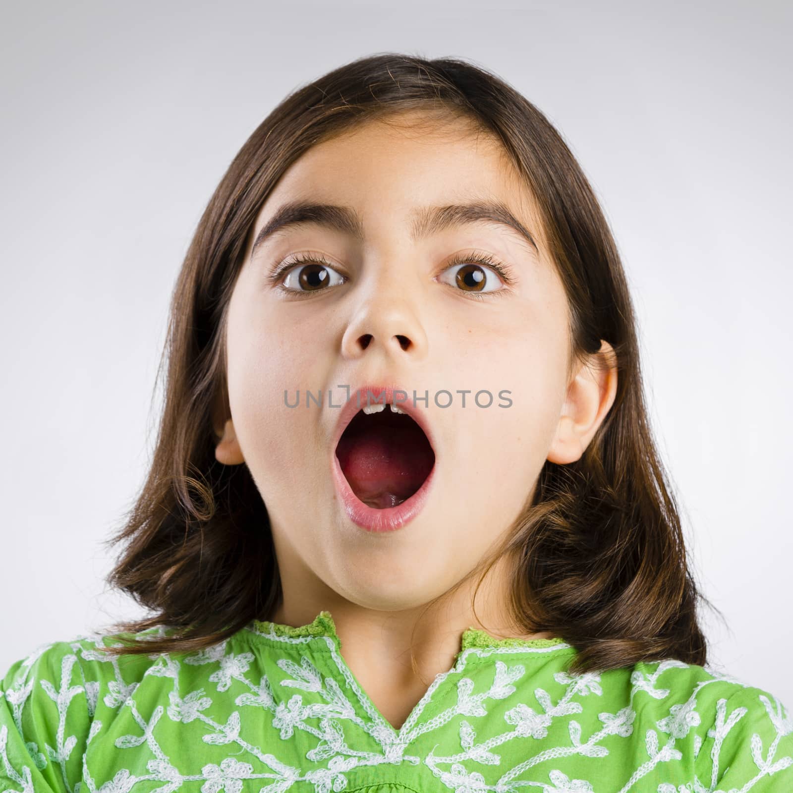 Portrait of a little girl making a astonished mouth expression