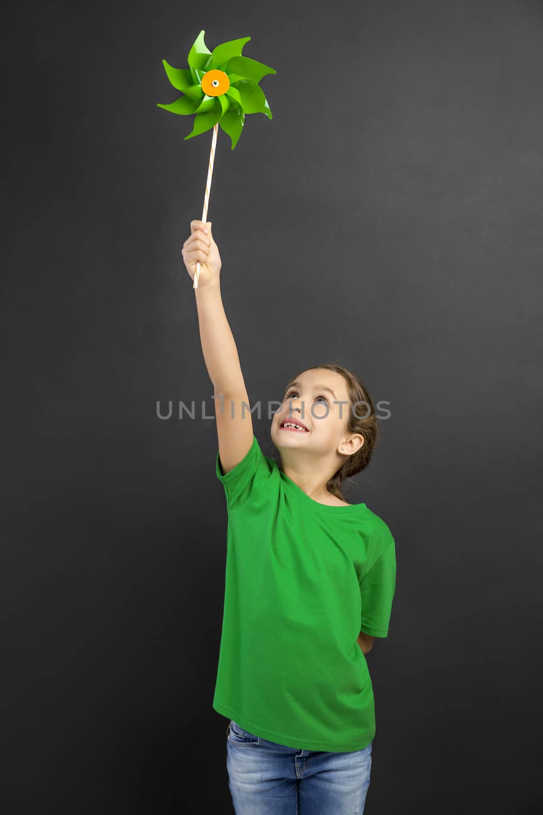 Beautiful little girl smilling and holding a windmill