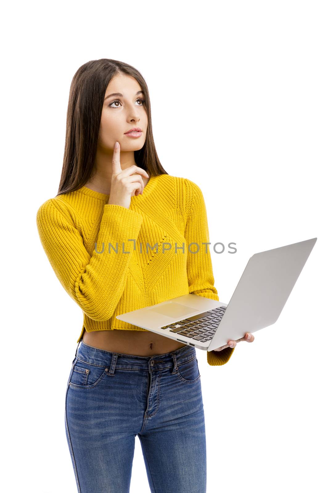 Beautiful and happy girl working with a laptop, isolated over white background 