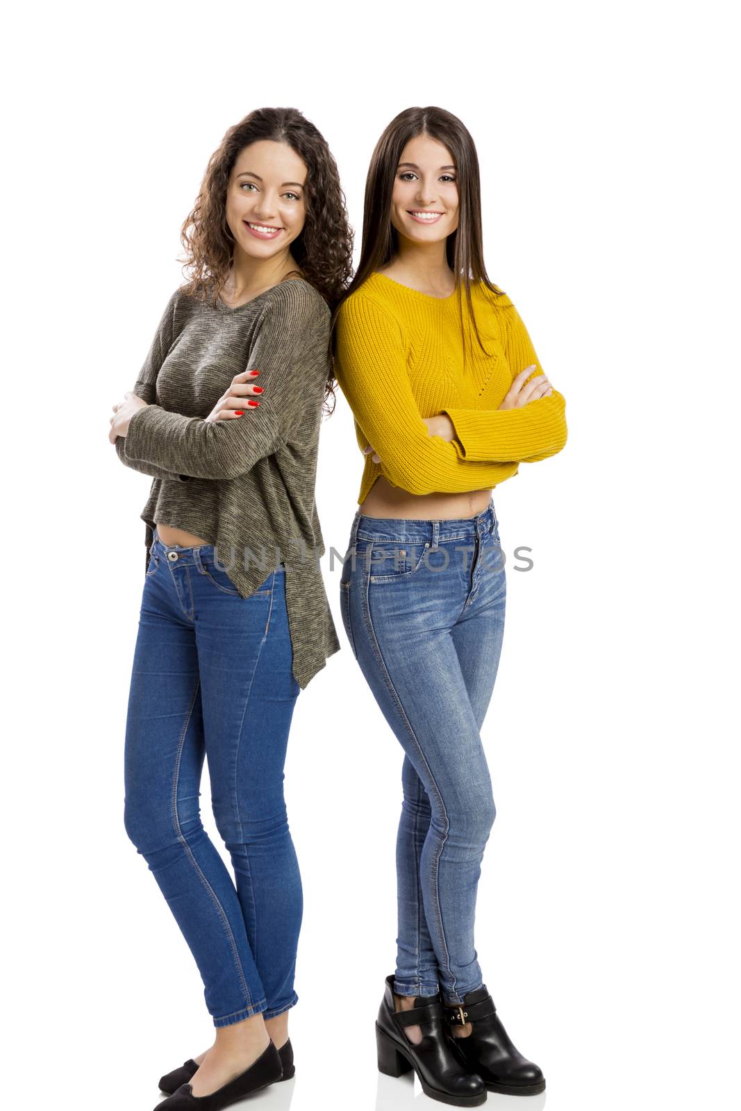 Studio portrait of two beautiful girls smiling