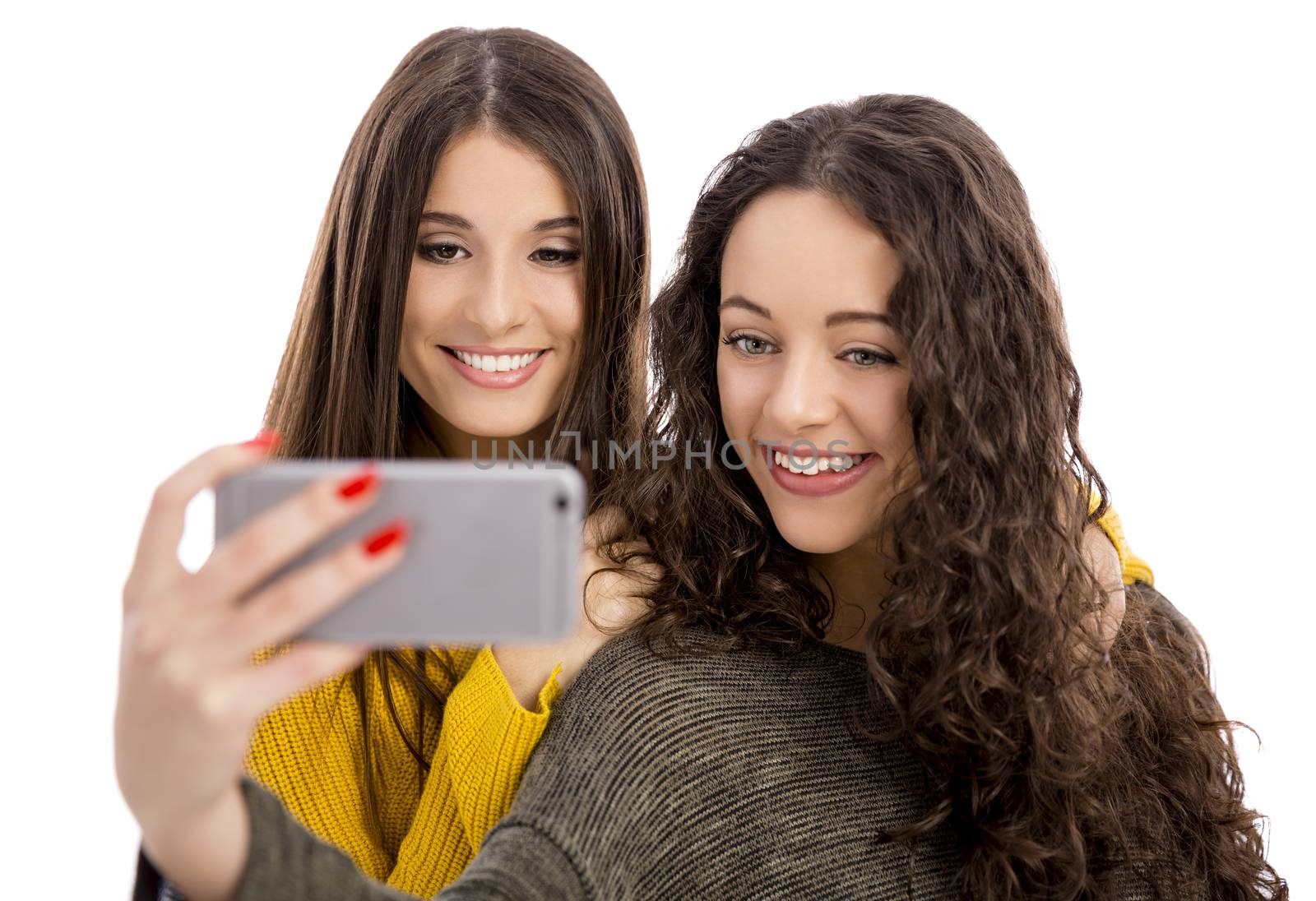 Teen girls with smartphone taking selfie