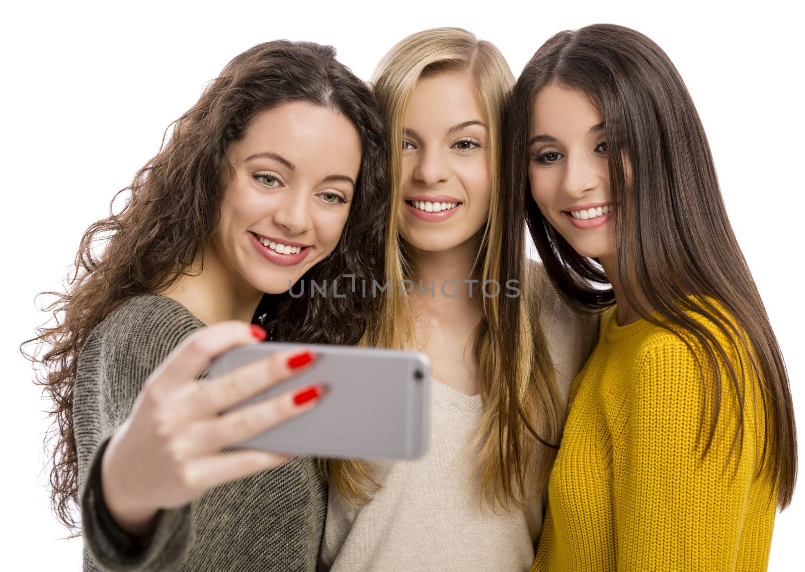 Teen girls with smartphone taking selfie