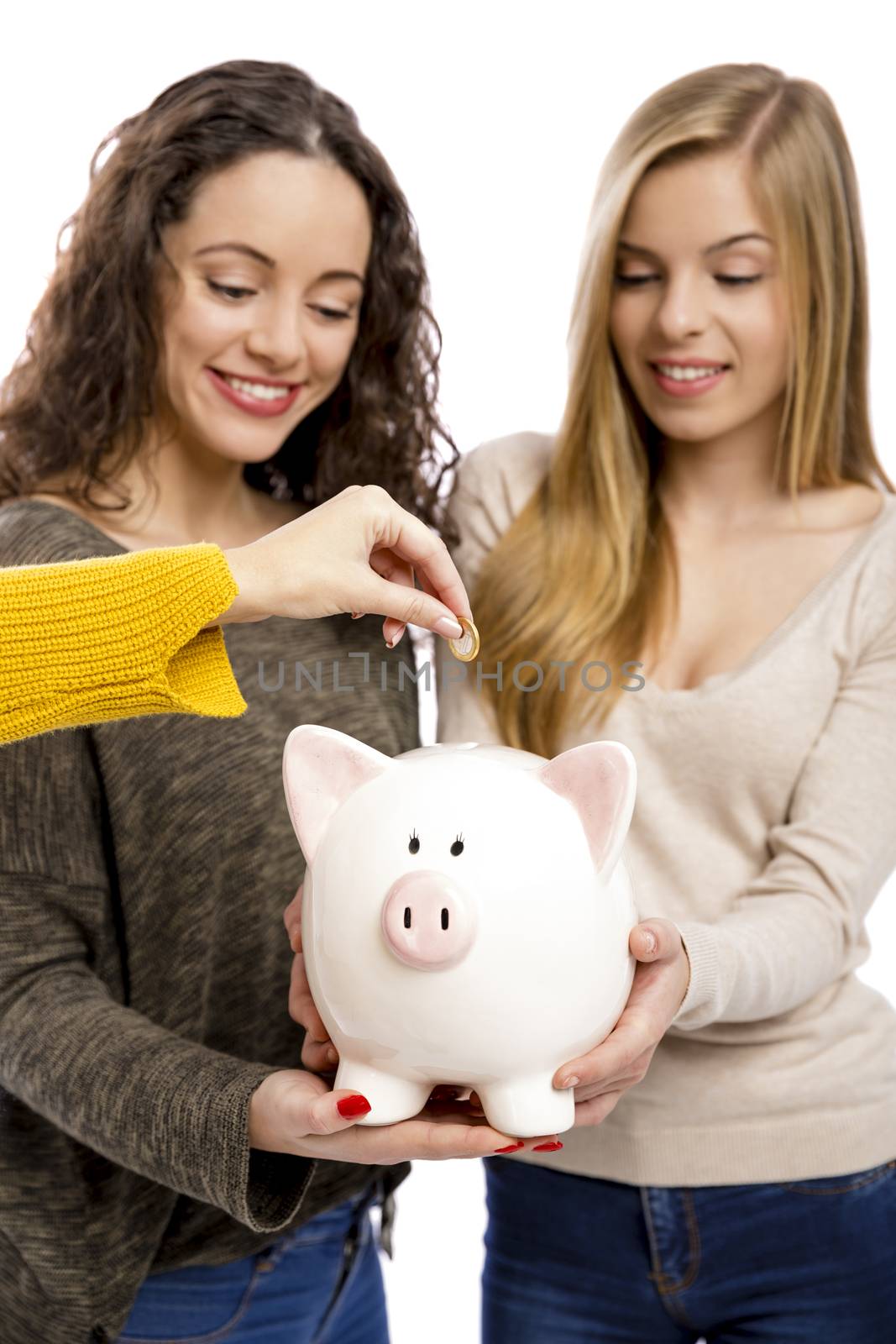 Teenage friend holding a piggy-bank and making some savings for the future