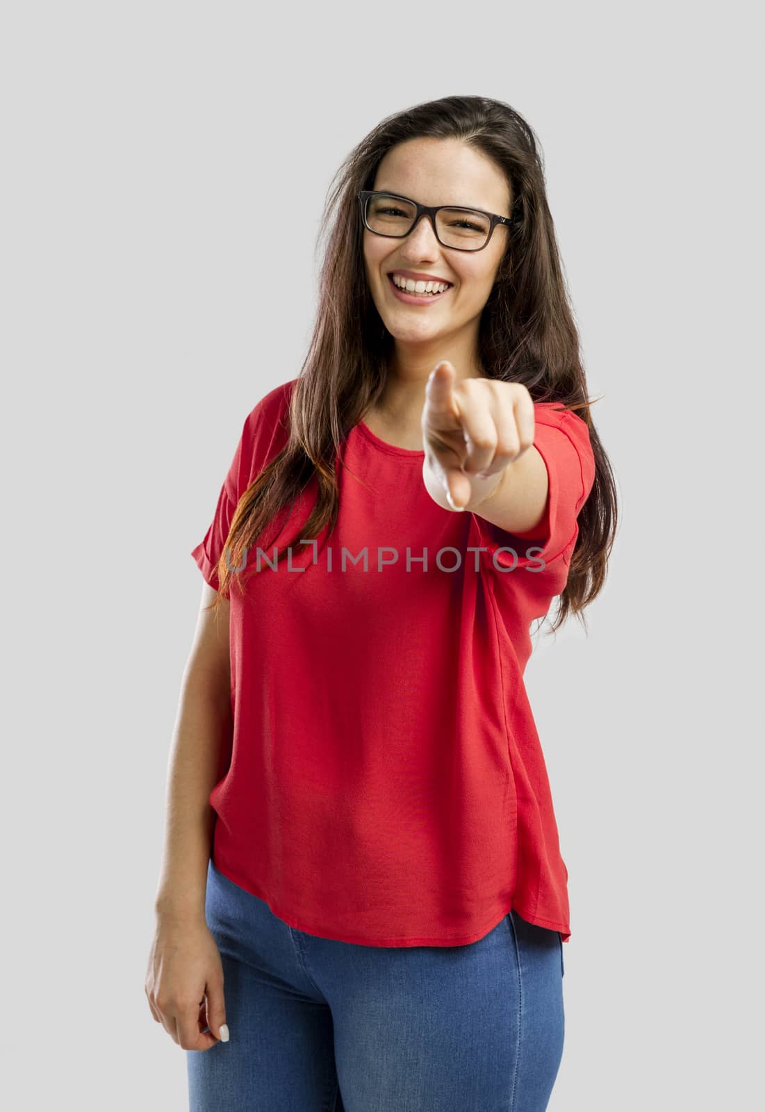 Happy woman smiling and pointing to the camera