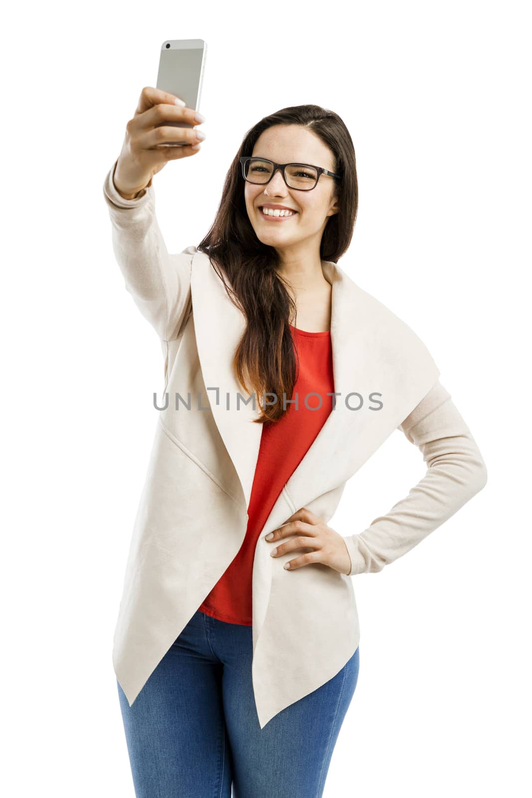 Beautiful woman making a  selfie with the phone, isolated over white background