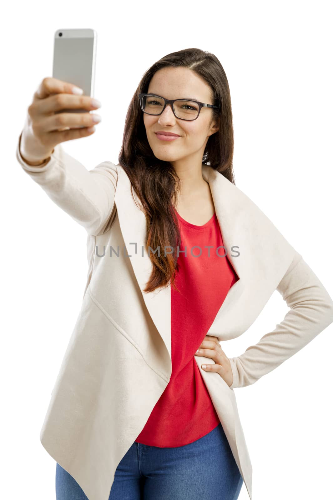 Beautiful woman making a  selfie with the phone, isolated over white background