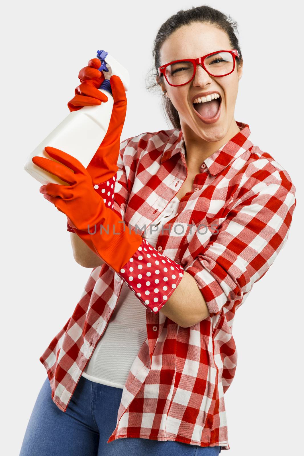 Pretty woman wearing gloves and holding a cleaning spray 