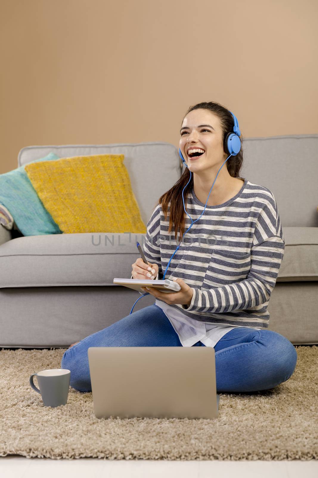 Beautiful woman at home studying while listen music