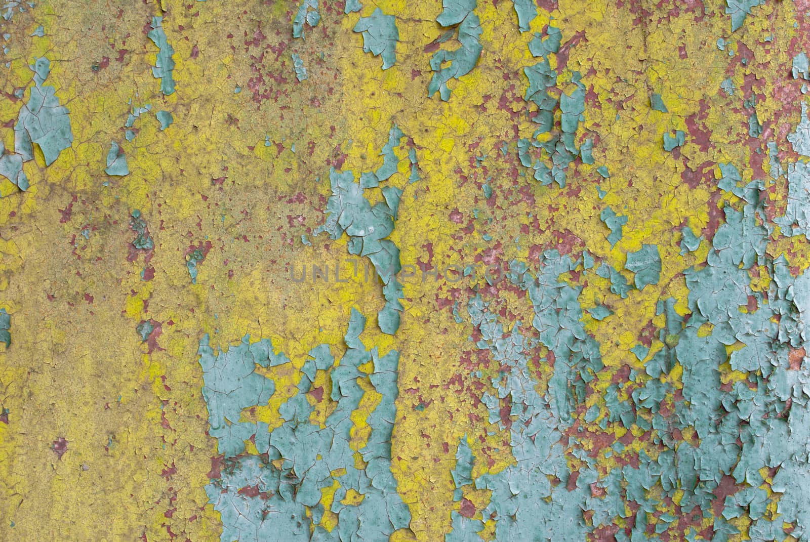 fragment of an iron surface is covered with paint, which has long been under the influence of different climatic conditions