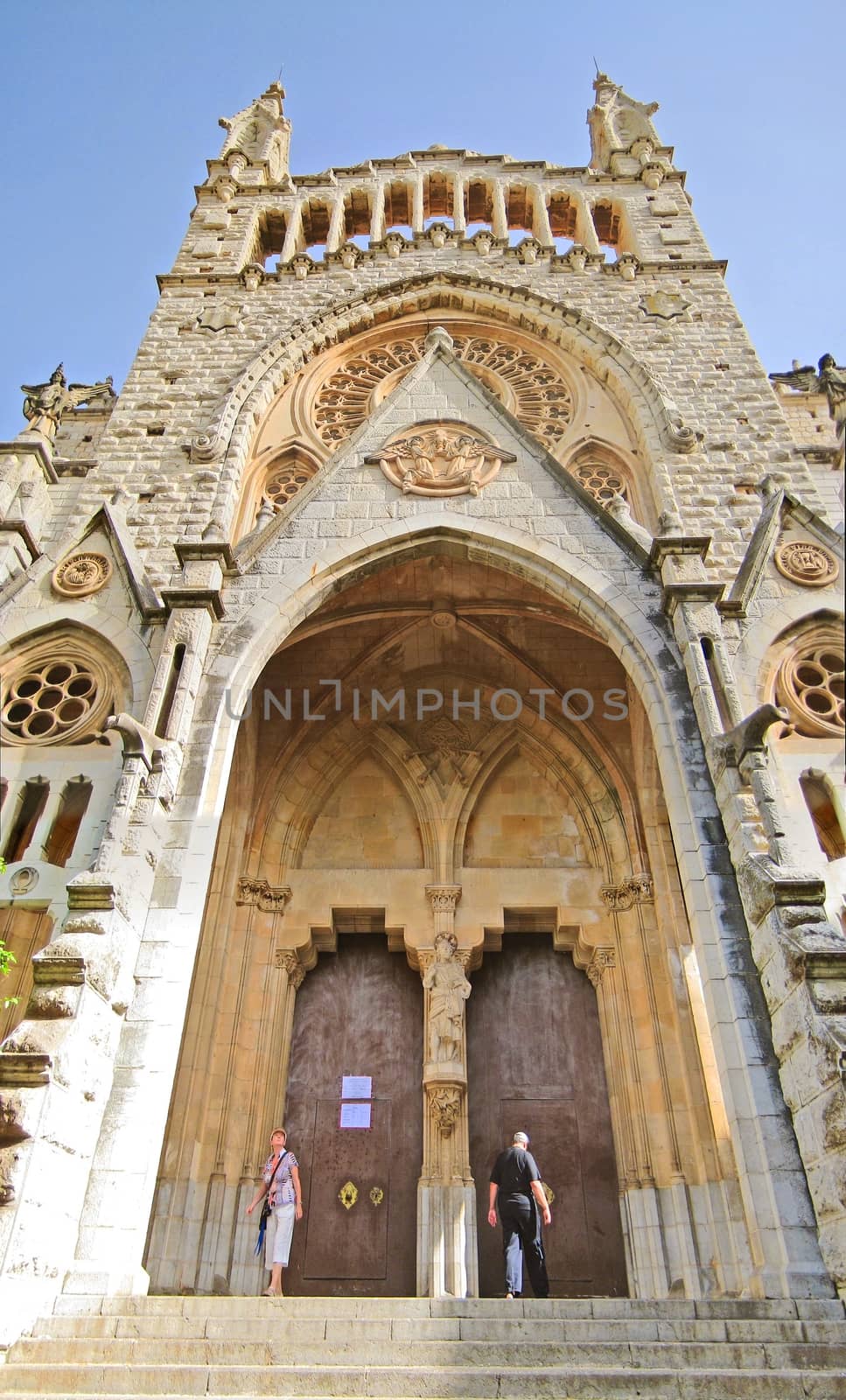 Soller, Majorca, Spain - June 23, 2008: Church of Soller Sant Bartomeu, Majorca - front view. People at the entrance portal doors.