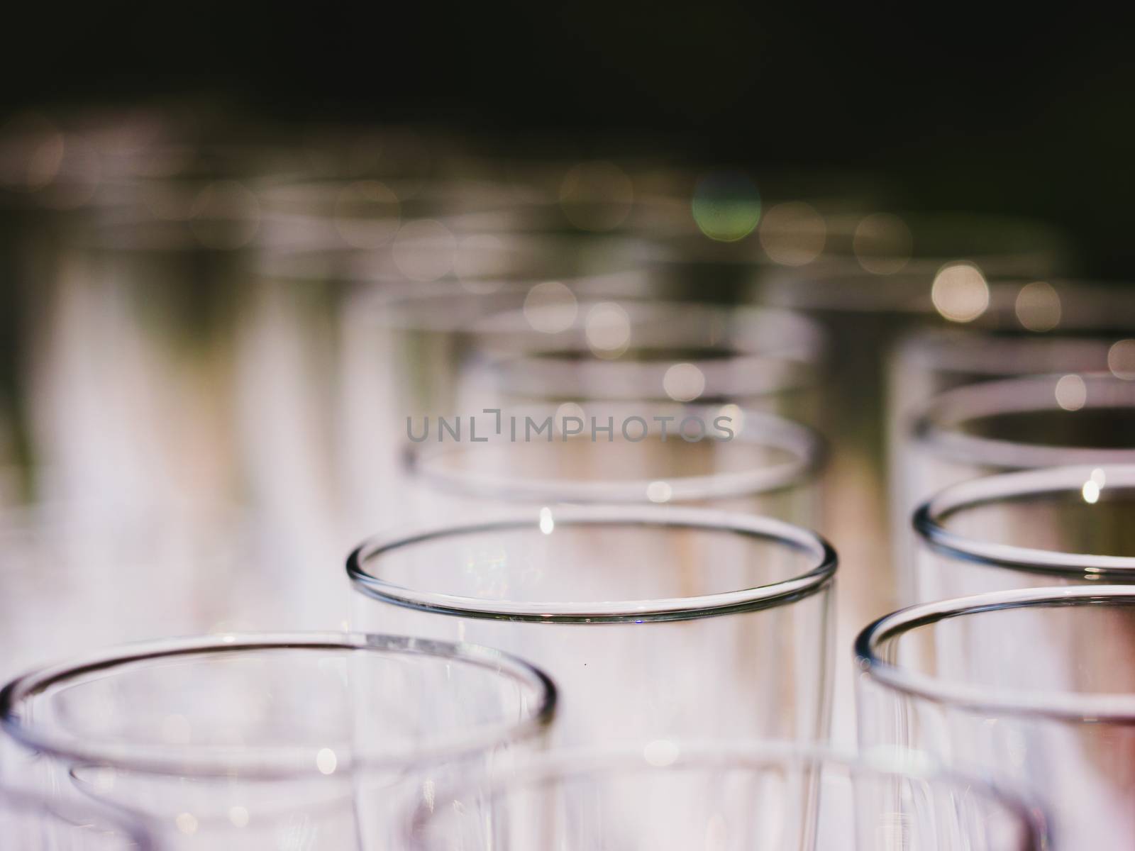 Row of glasses macro shot. Empty glasses on a banquet table close up