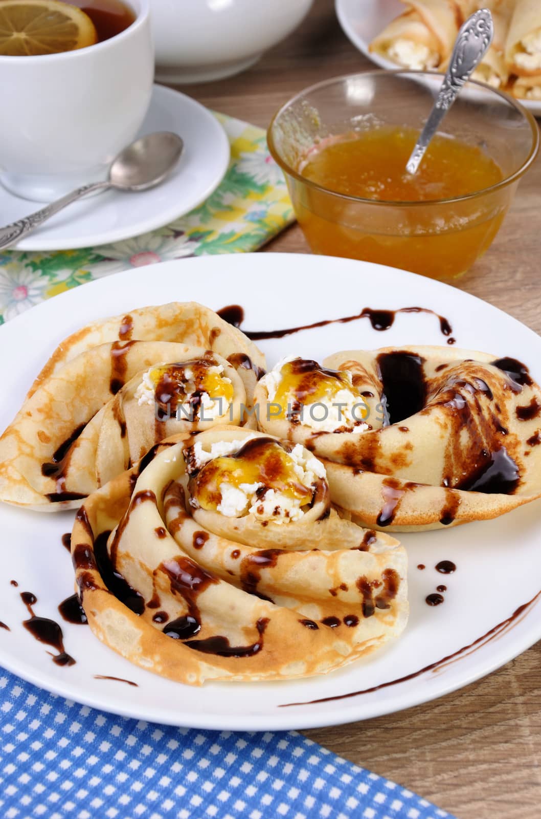 Pancake folded in the form of a snail cottage cheese with chocolate