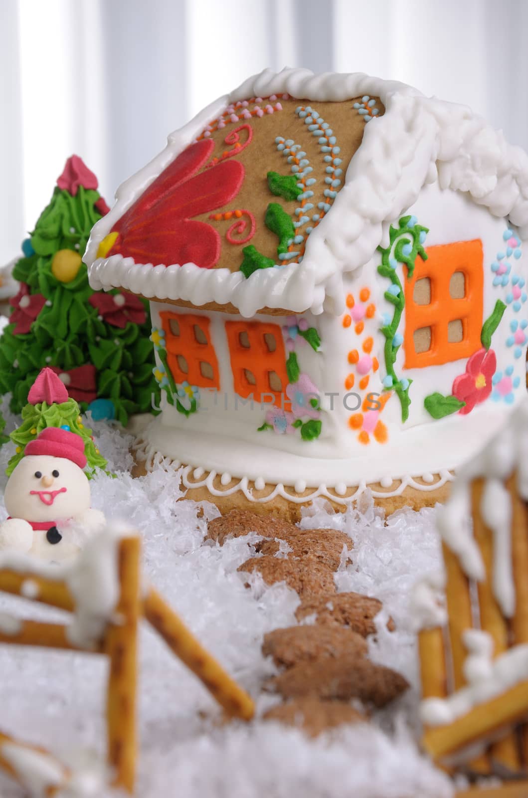 Gingerbread house painted in ethnic style among the trees and snow