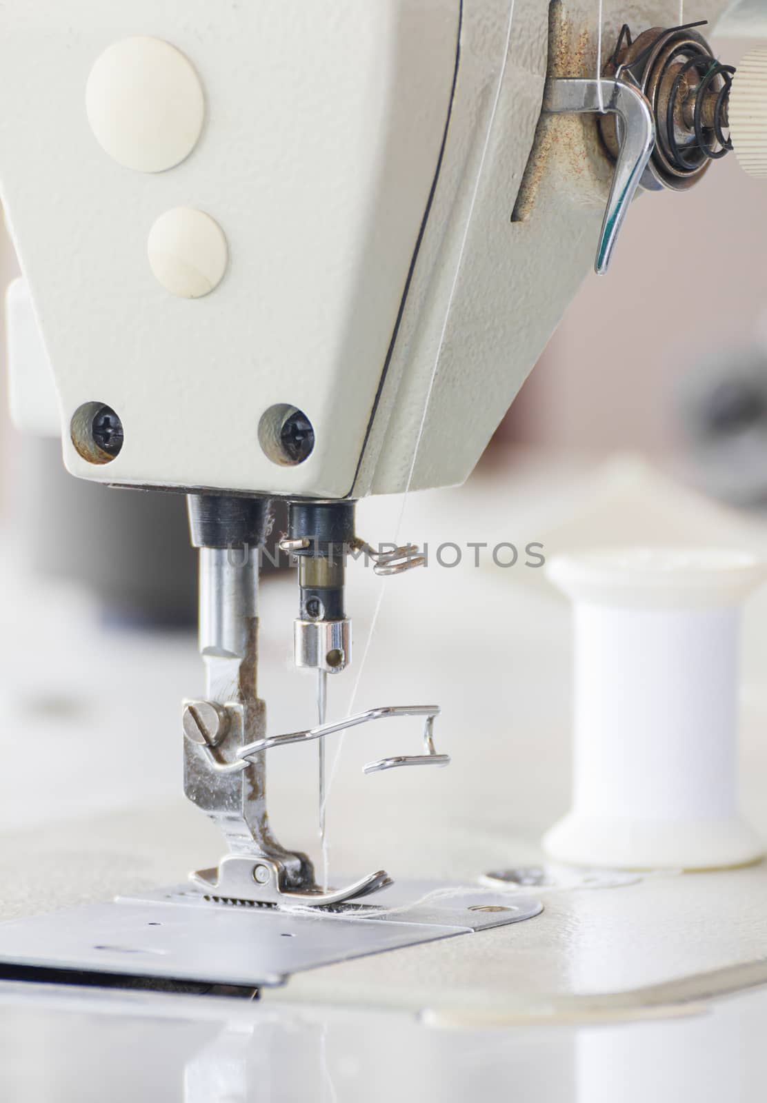 Close up industrial sewing machine by stoonn