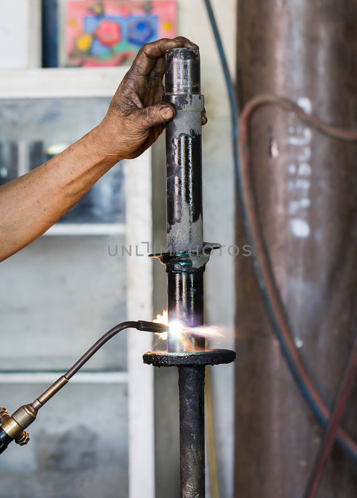 Welders were repairing cutting Shock absorbers of a car in workshop