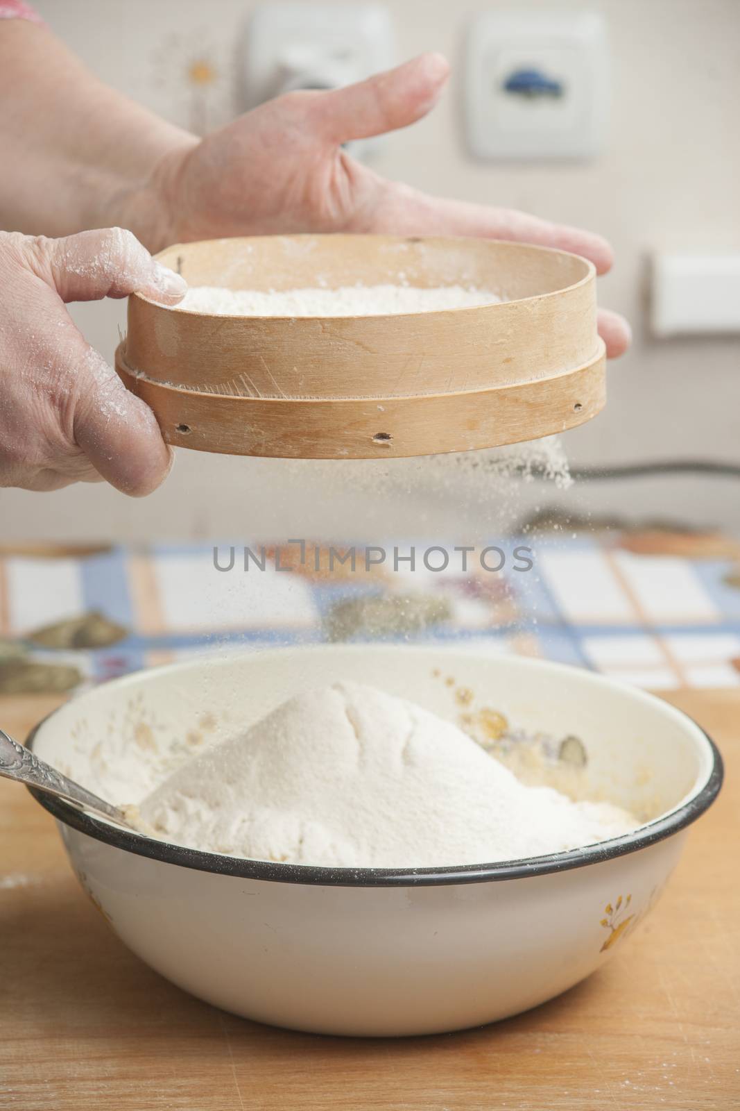 Women's hands preparing flour before baking pie by kozak