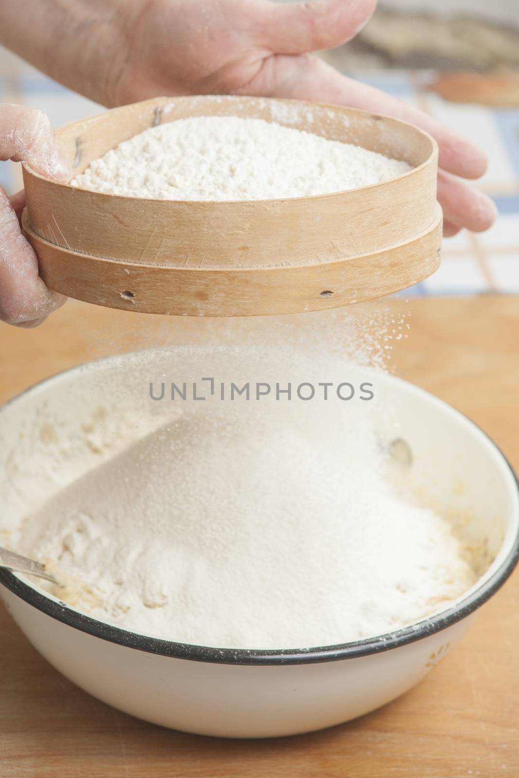 Women's hands preparing flour before baking pie by kozak