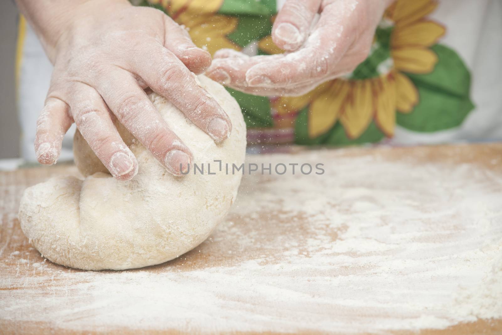 Women's hands preparing fresh yeast dough by kozak