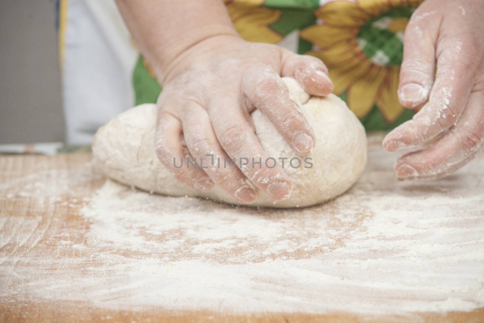 Women's hands preparing fresh yeast dough by kozak