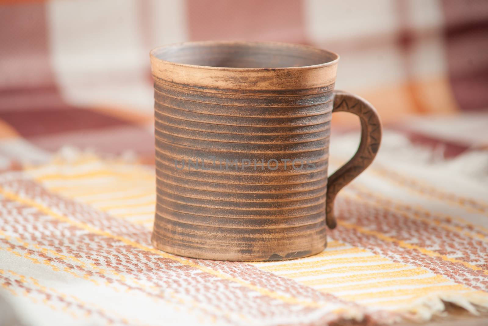 Traditional handcrafted mug on multycolor background. High resolution