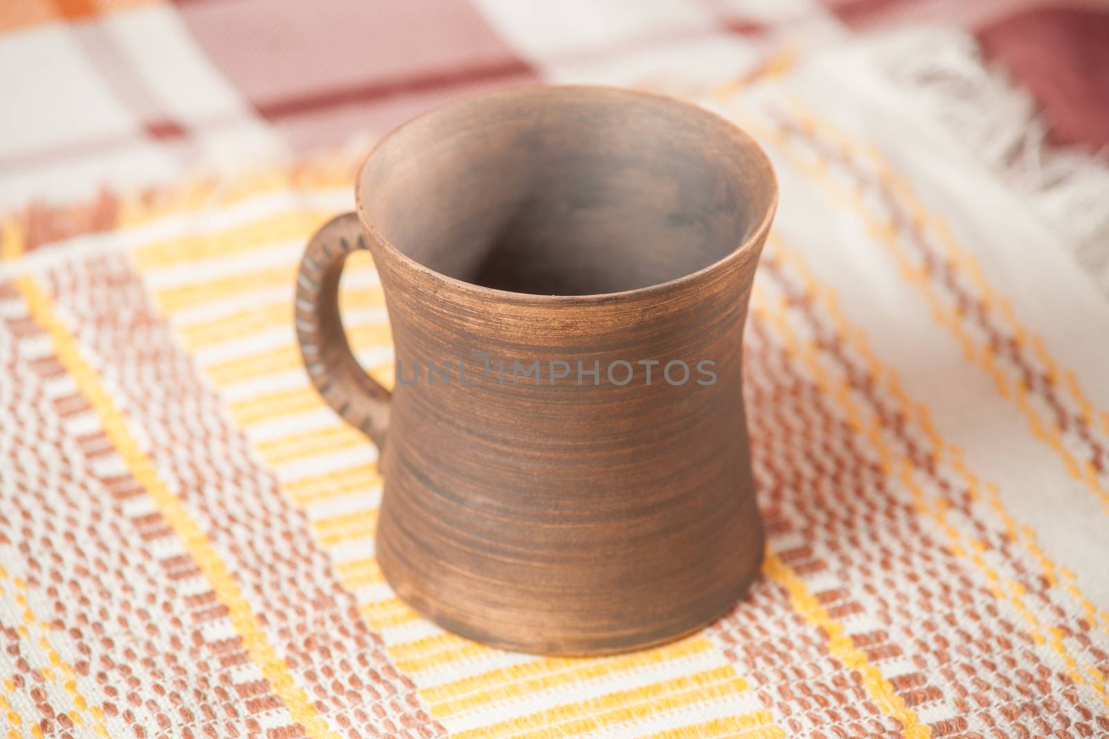 Traditional handcrafted mug on multycolor background. High resolution