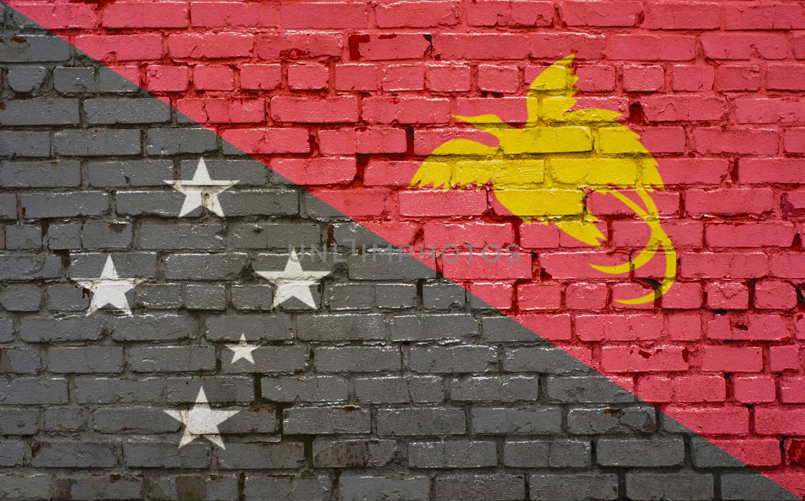 Flag of Papua New Guinea painted on brick wall, background textu