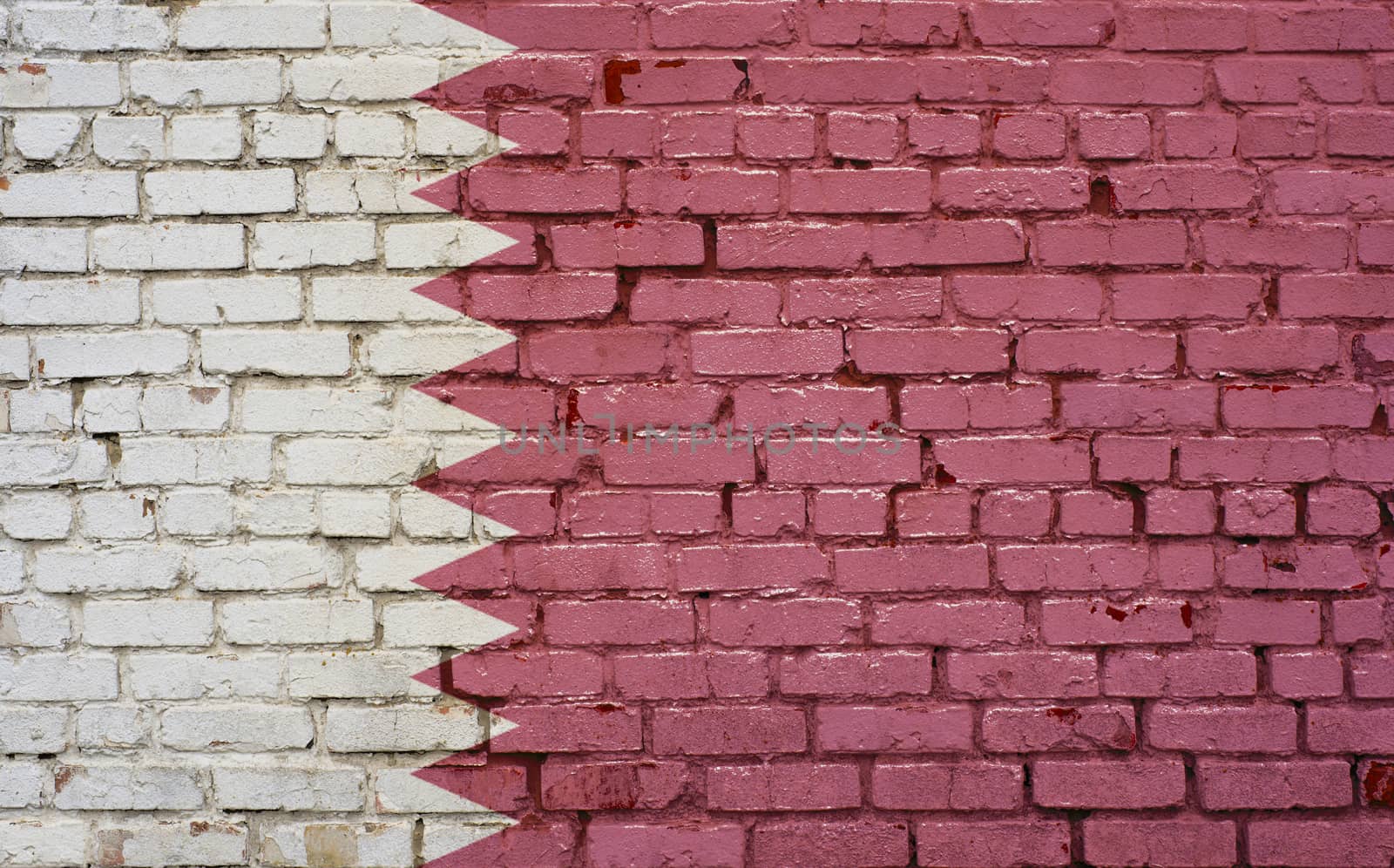 Flag of Qatar painted on brick wall, background texture