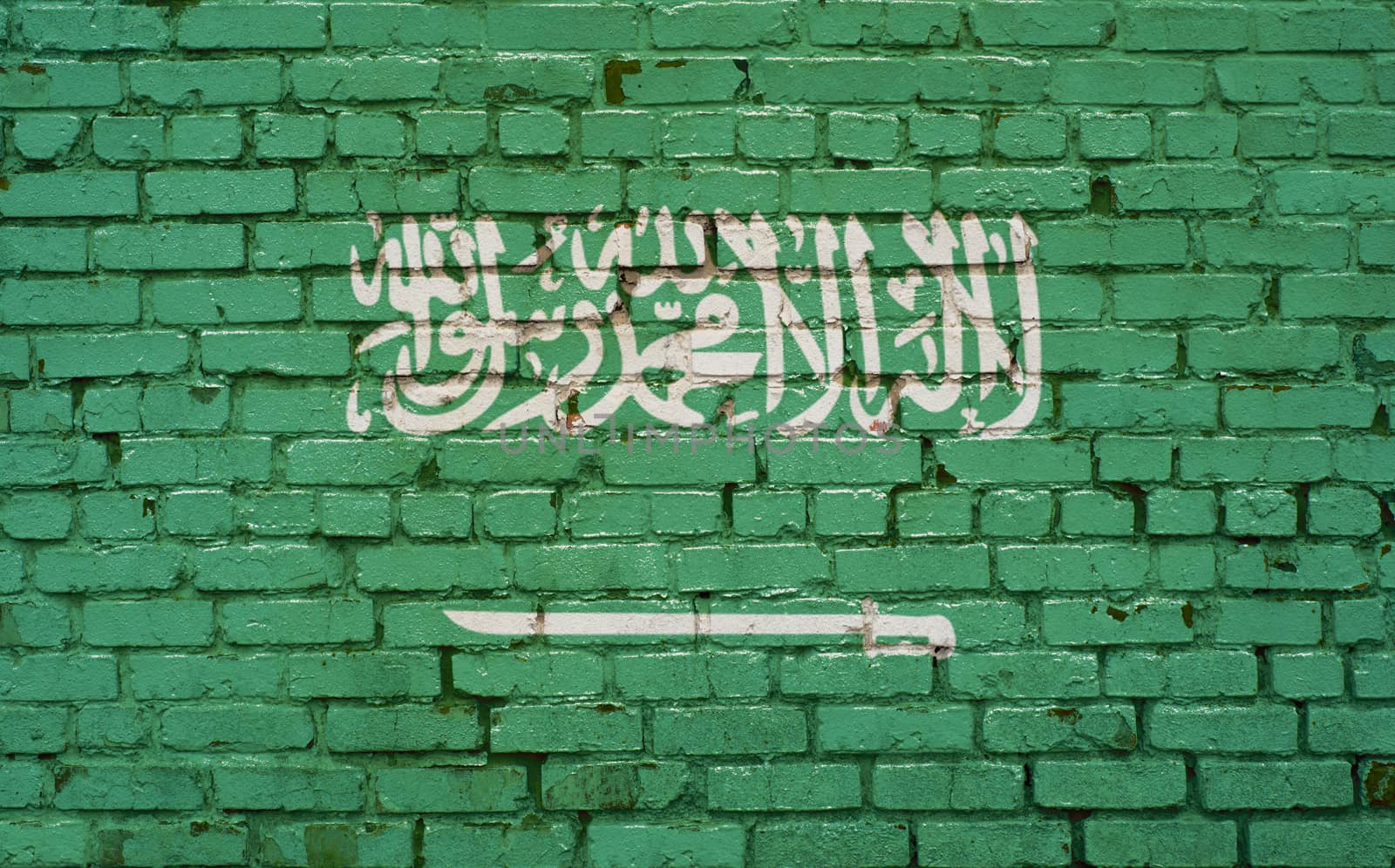 Flag of Saudi Arabia painted on brick wall, background texture