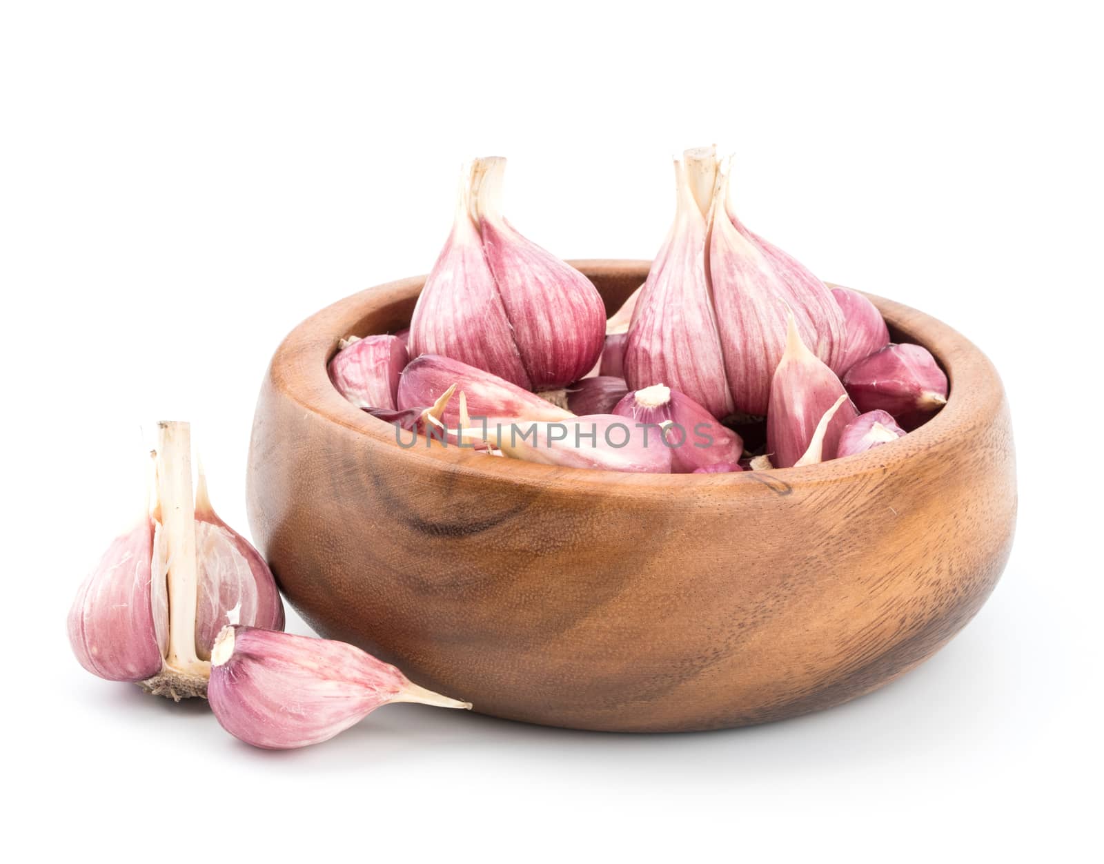 Garlic on wooden bowl of white background