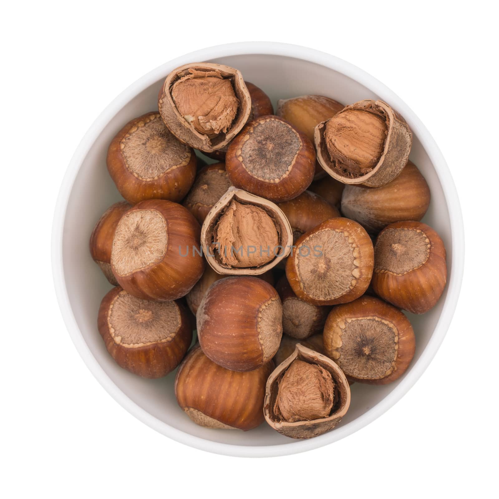 Haselnuts in bowl. Isolated on white background