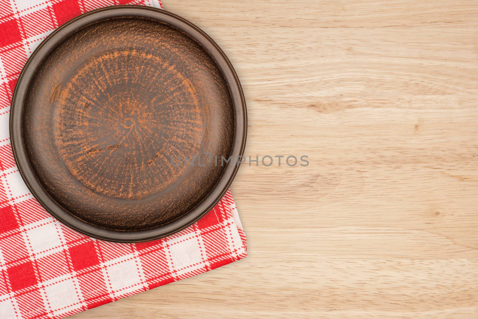 Brown clay plate on the table