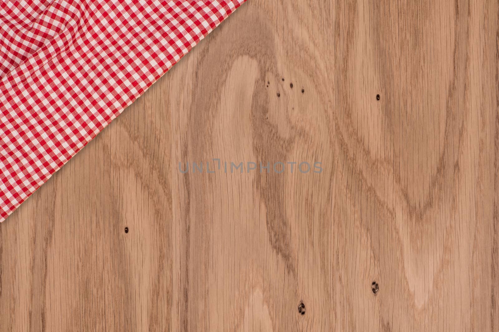 Background with wooden tabletop and checked tablecloth