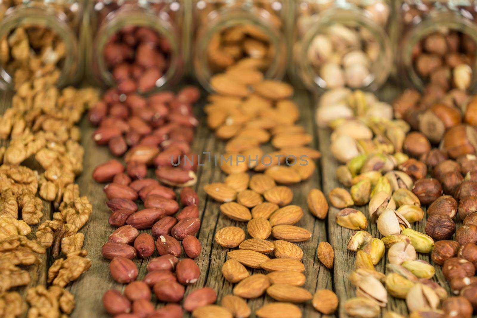 Mix of nuts in the glass jars , on the table, selective focus