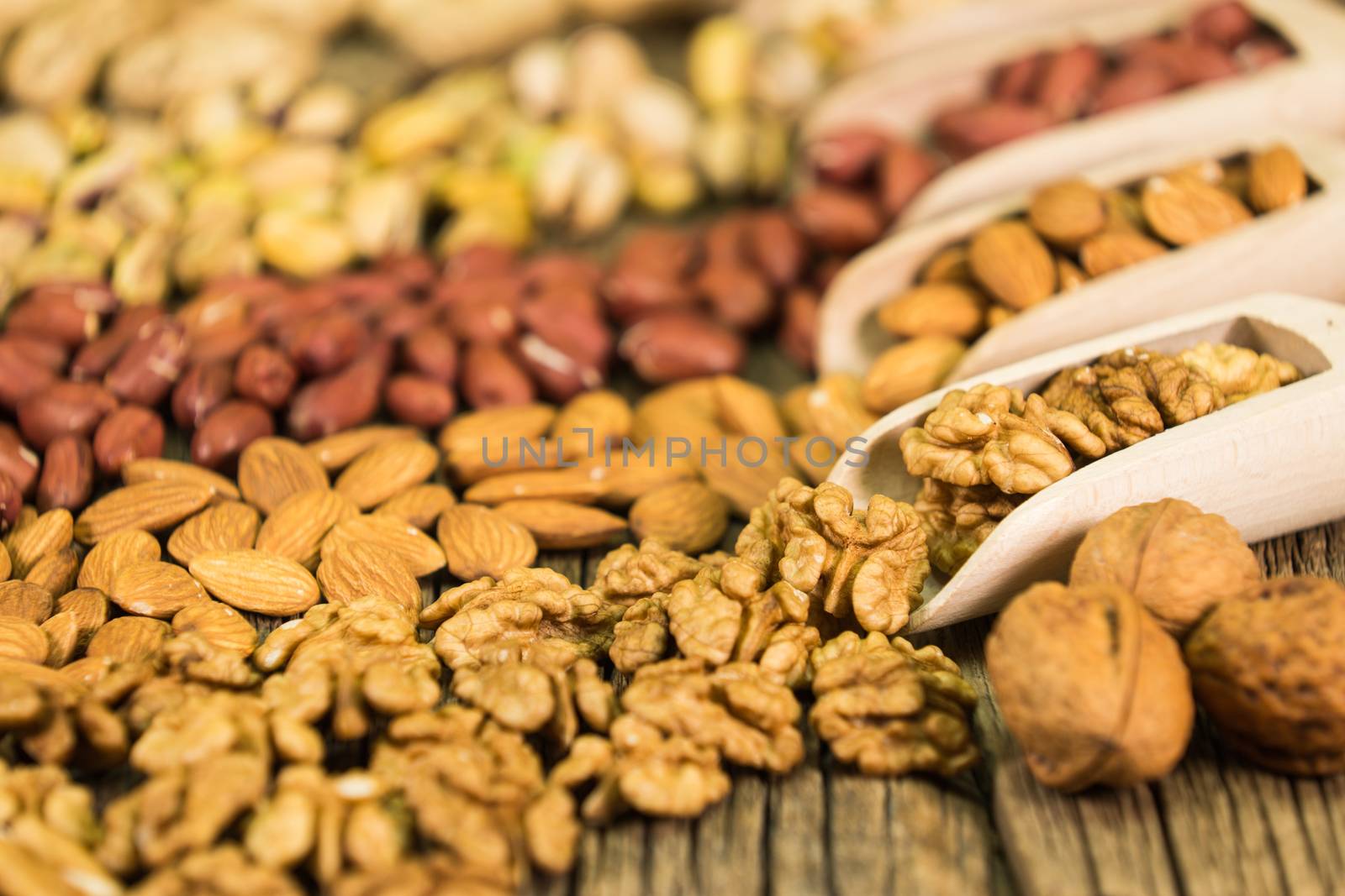 Walnuts in a wooden scoop, nut mix, selective focus