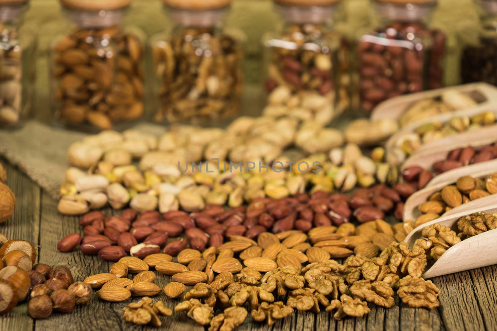 Salted pistachios in a glass jar, nut mix, selective focus